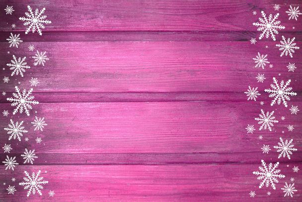 Winter wooden pink rose magenta purple nature background with snowflakes two sides. Texture of painted wood horizontal boards. Christmas, New Year card with copy space. Can be used for websites, brochures, posters, printing and design. This is a wond - Photo, Image