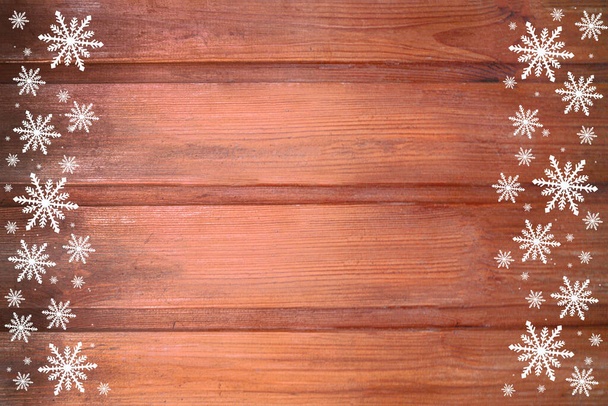 Winter wooden beige pink rose red brown nature background with snowflakes two sides. Texture of painted wood horizontal boards. Christmas, New Year card with copy space. Can be used for websites, brochures, posters, printing and design. This is a won - Photo, Image
