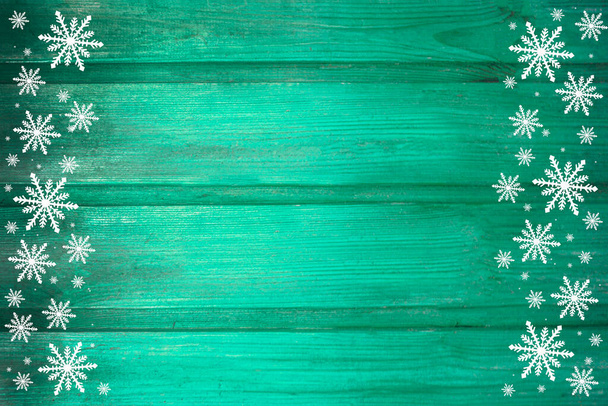 Winter wooden green yellow nature background with snowflakes two sides. Texture of painted wood horizontal boards. Christmas, New Year card with copy space. Card for congratulation, invitation, party, message for Christmas, New Year. - Photo, Image