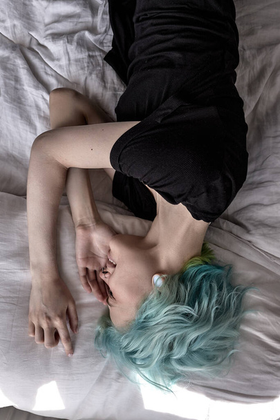 above view on stressed sad woman lying on bed looking desperate. human emotions - 写真・画像