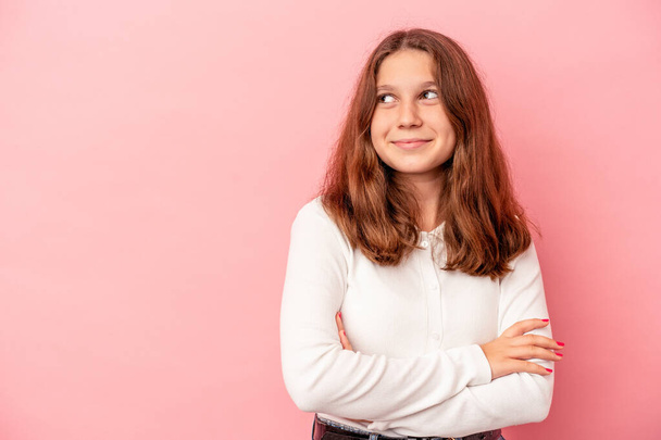 Little caucasian girl isolated on pink background smiling confident with crossed arms. - Photo, Image
