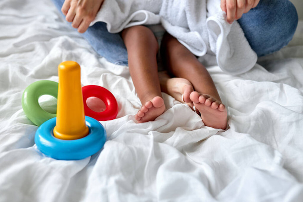 Close-up portrait of childs feet on bed, free spare time of family indoors - Foto, immagini