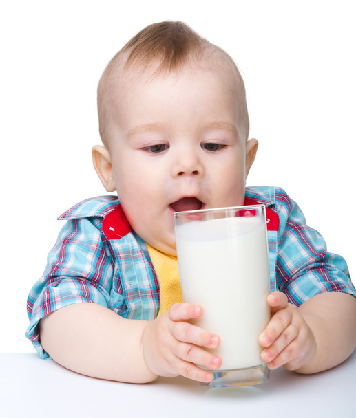 Cute little boy is going to drink milk from glass - Fotoğraf, Görsel