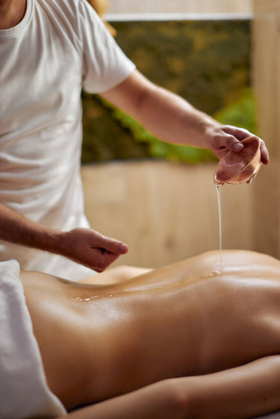 Aromatherapy massage therapy using massage oil or lotion, essential oils for woman - 写真・画像