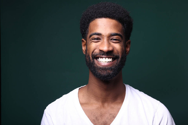 Portrait of a beautiful happy man in front of a colored background - Photo, image