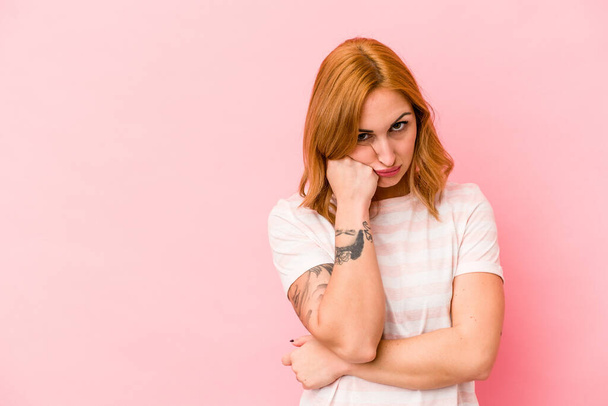 Young caucasian woman isolated on pink background who feels sad and pensive, looking at copy space. - Photo, Image