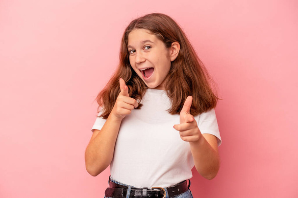Little caucasian girl isolated on pink background pointing to front with fingers. - Foto, imagen