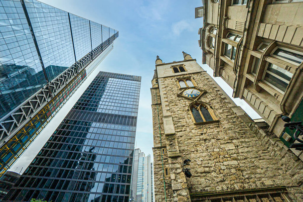 There are office buildings, skyscrapers, churches in the business against the background of blue sky and white clouds district of London, UK. Can be used for websites, brochures, posters, printing and design. - 写真・画像