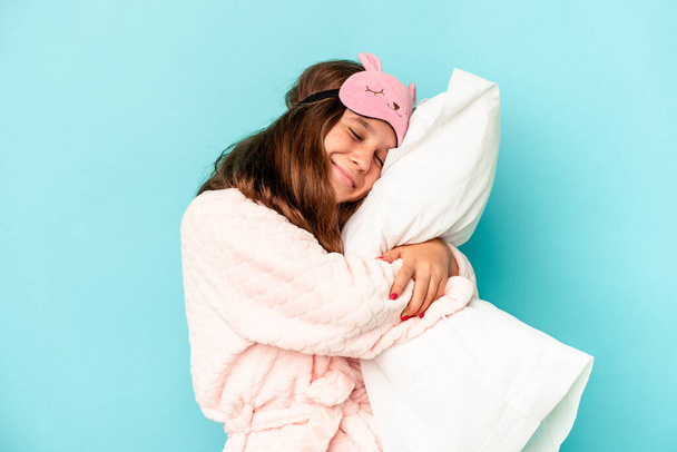 Little caucasian girl going to sleep isolated on blue background - Photo, Image