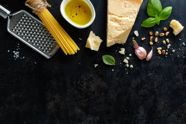 Pesto ingredients on dark background. View from above.  - Foto, Bild