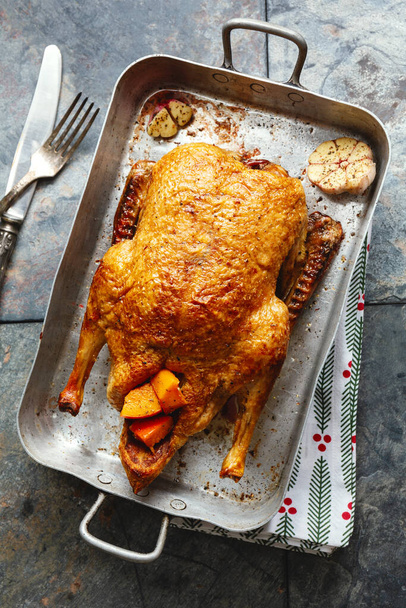 Baked roasted duck with vegetables on pan on stone background. Top View.  - Foto, Bild