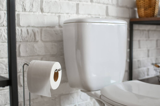 Holder with toilet paper roll in restroom - Valokuva, kuva