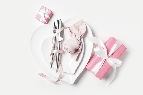 Stylish table setting and gifts for Valentine's Day on white background - Foto, imagen