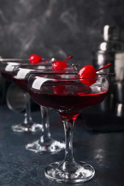 Glasses of tasty Manhattan cocktail on black background - Фото, изображение