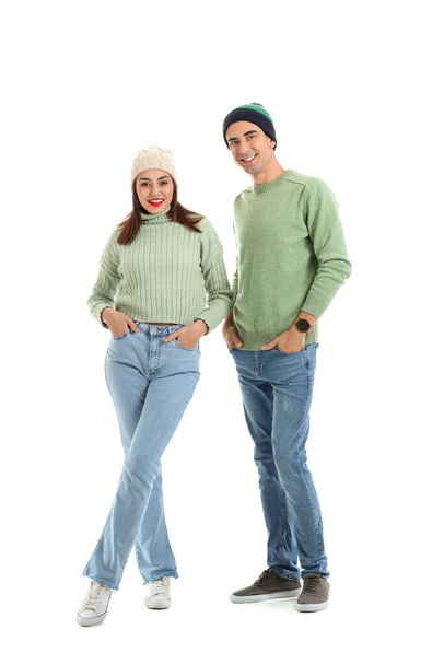 Happy young couple in warm sweaters on white background - Foto, immagini