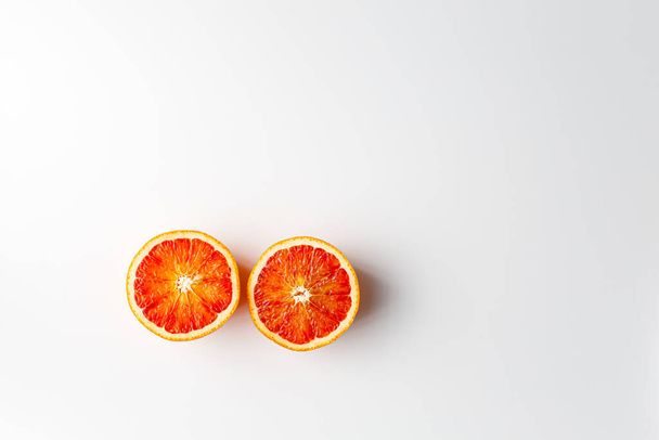 Red blood orange fruit with slices isolated on white background. Whole ripe juicy Sicilian Blood oranges. Selective focus. Isolated. Clipping path. - Photo, image