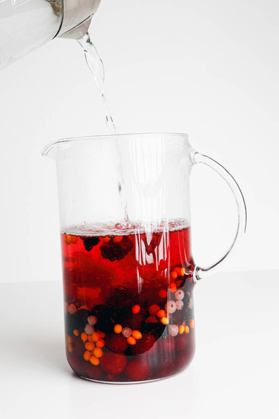 Homemade hot red wine sangria with orange, apple, cherry, raspberry. Hot sea buckthorn tea with ginger, white currant, honey, Vitaminic healthy. Immune system booster food, antiviral beverage. - Фото, изображение