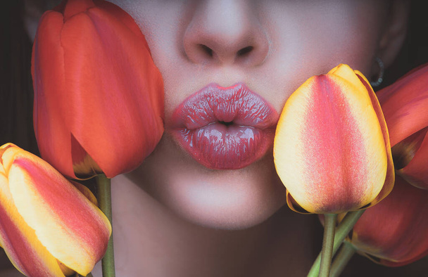 Woman with tulips kiss. Sensual lips. Kissing. 8 march womens day. - Fotó, kép