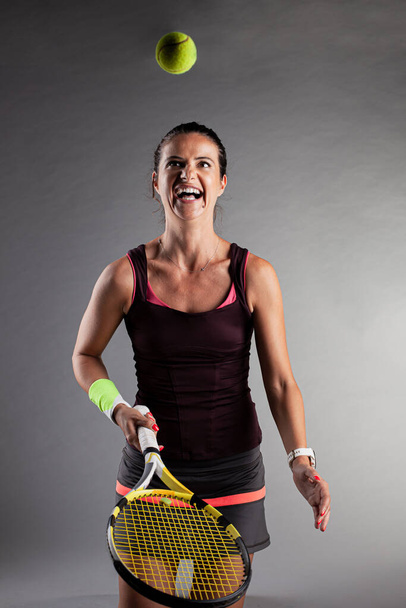 Professional female tennis player. Girl swinging racket. - Fotó, kép