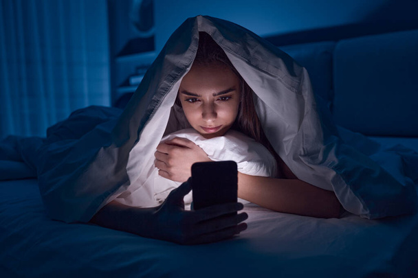 Young woman using cellphone at night - Photo, Image