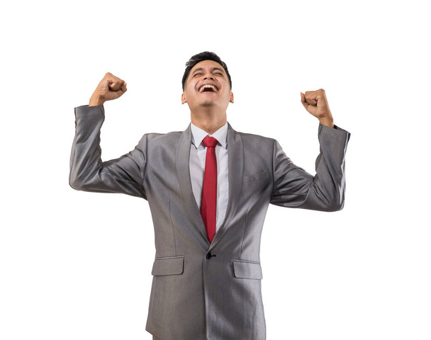 excited young businessman raise his hand isolated over white - Foto, Bild