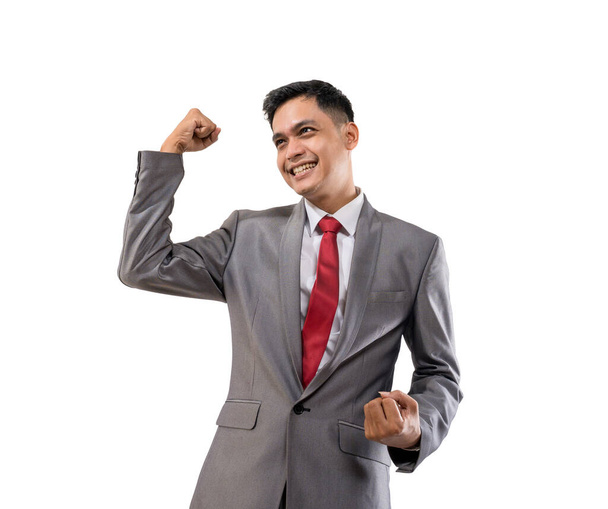excited young businessman raise his hand isolated over white - Φωτογραφία, εικόνα