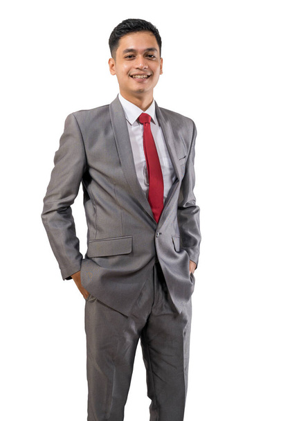 handsome businessman put his arm on a pocket isolated over white background - Foto, Imagen
