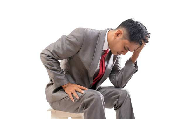 businessman in his suit feeling stressed hold his head - Photo, Image