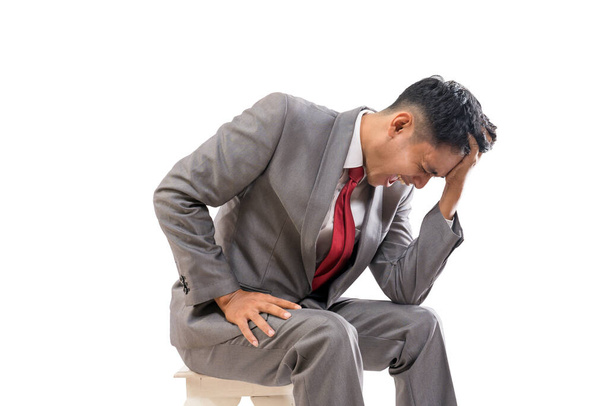 businessman in his suit feeling stressed hold his head - Photo, Image