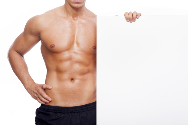 Fitness man holding a white banner - Foto, immagini