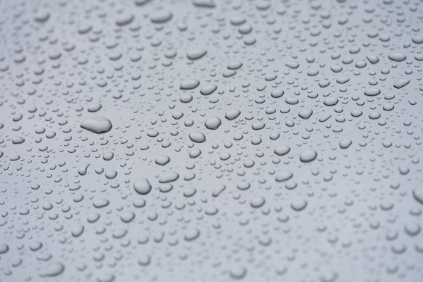 Small droplets of water on a matte gray background - Fotó, kép