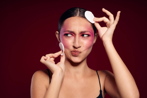 Portrait of beautiful young woman bright makeup posing fashion emotions cosmetics pink background unaltered - Foto, Bild