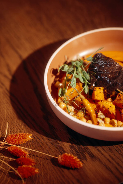 Baked pumpkin with meat and vegetables. - 写真・画像