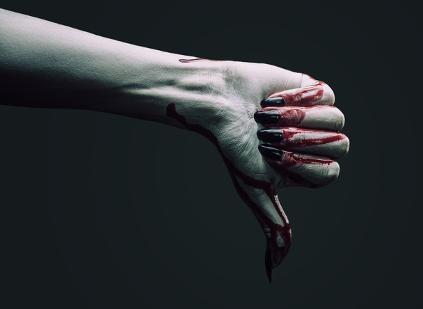 Vampire hand shows thumb down gesture - Foto, afbeelding