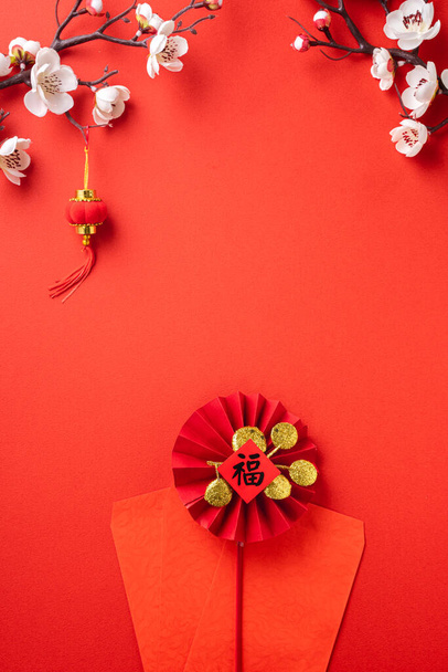 Top view of Chinese lunar new year background copy space design concept with white plum blossom and festive decoration, the word inside picture means blessing. - Foto, Imagem