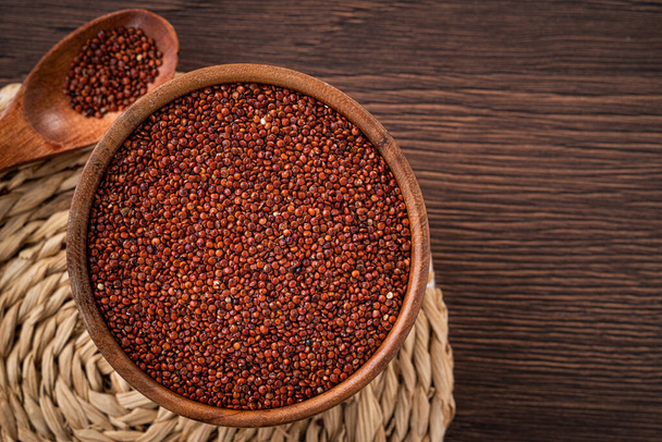 Top view of organic red  in a bowl on wooden table background. - Фото, изображение