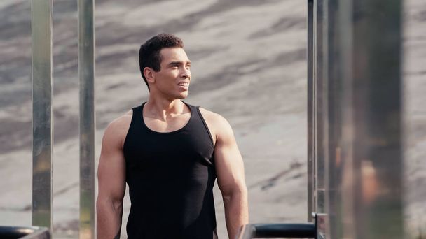athletic mixed race man looking away at outdoor gym on blurred foreground - Φωτογραφία, εικόνα