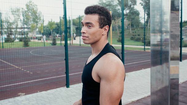 athletic mixed race man standing at outdoors gym - Fotó, kép