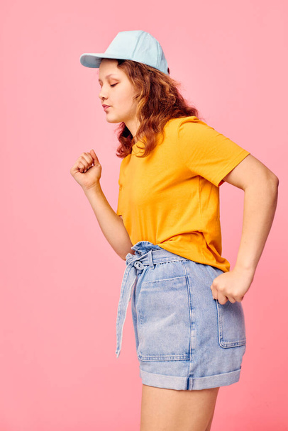 funny girl in a yellow t-shirt and blue cap posing emotions Lifestyle unaltered - Fotoğraf, Görsel