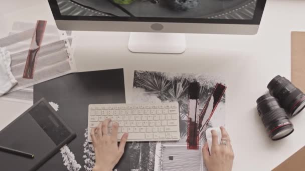 Вид зверху знімок рук невпізнаваної жінки-фотографа редагування фотографії на комп'ютері за допомогою миші і клавіатури
 - Кадри, відео