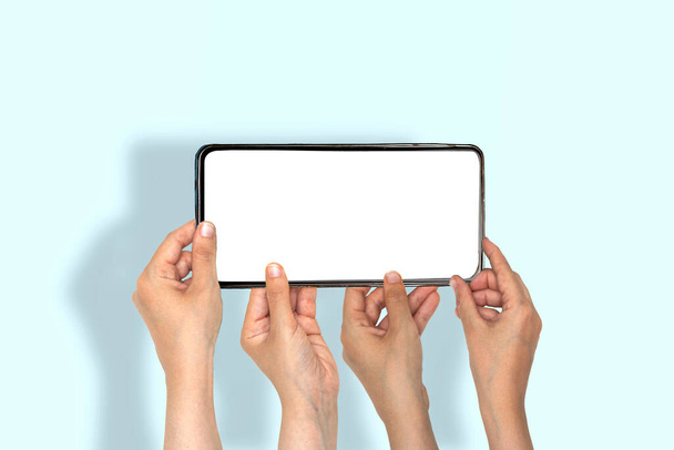 Mobile offer. closeup hands people holding a huge cellphone with empty white screen. recommending cool new app or website, offering space for your ad, mockup - Foto, imagen