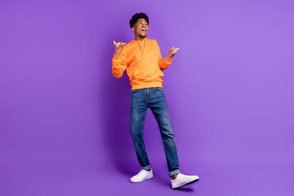 Full length body size view of attractive cheerful brunet guy having fun isolated over bright violet purple color background - 写真・画像