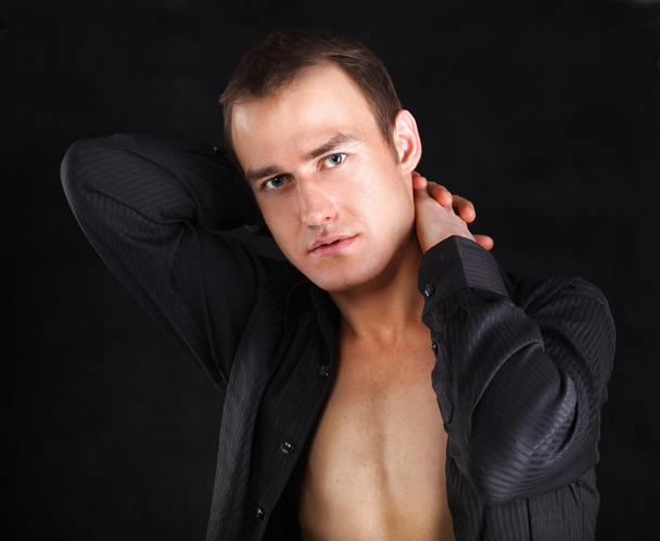 Portrait of a naked muscular man, isolated on black - Fotografie, Obrázek