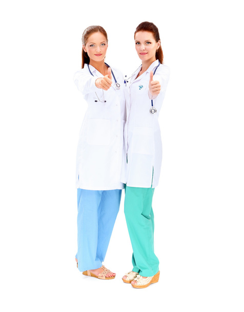 Two young woman doctor showing ok , standing in hospital - Fotoğraf, Görsel