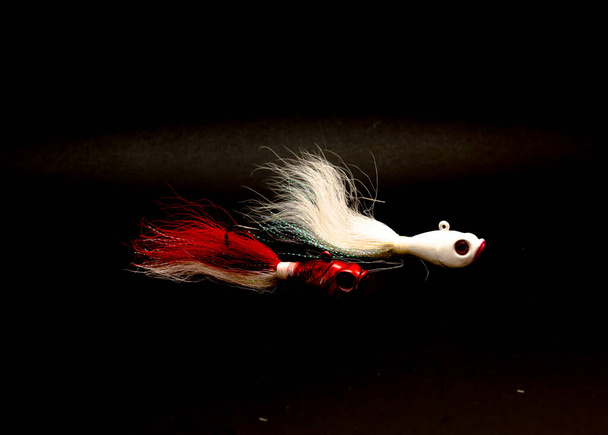 Two bucktail Jig heads lure hand tie deer hair fishing jig hooks isolated on black background. - Photo, Image
