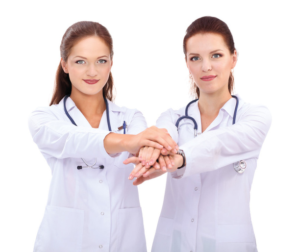 Yomg woman doctor stacking hands together over white background - Fotografie, Obrázek