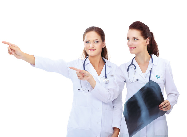 Two woman  nurse watching X Ray image, standing in hospital - Fotó, kép