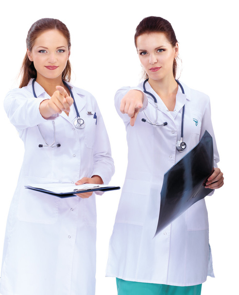 Two woman  nurse watching X Ray image and pointing to you , standing in hospital - Foto, imagen