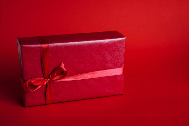 Banner with red gift box on red background for Christmas or Valentine's day. Copy space for your text. - 写真・画像
