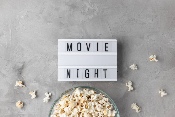 Text MOVIE NIGHT and popcorn in bowl. Movie theater and cinema snacks - Foto, Bild